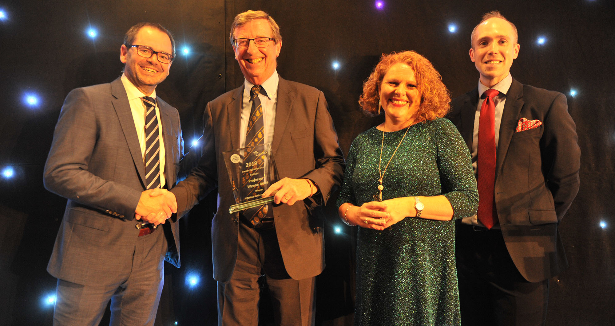 Professor Wynne Jones receiving his Lifetime Achievement Award from Mark Alexander (Welsh Government) and comperes Rachael Garside and Aled Jones