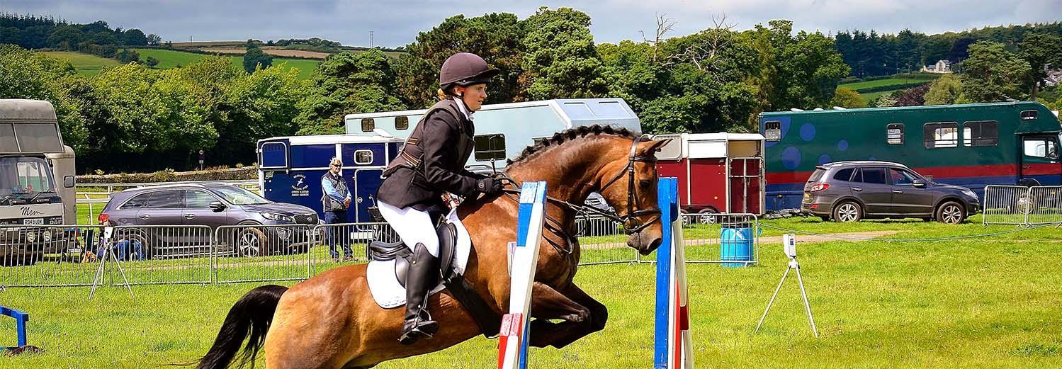 Horse jumping over an obstacle at an equine event